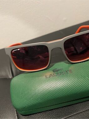 Lacoste Gray Frame Sunglasses with Orange Trim and Red Lenses